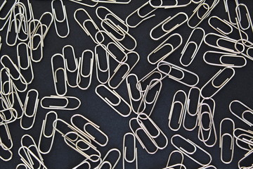 metallic paper clips silver color black background