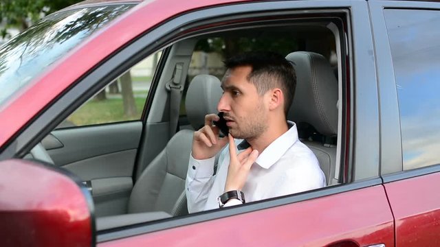 Young driver being impatient, waiting inside his car and showing signs of frustration.