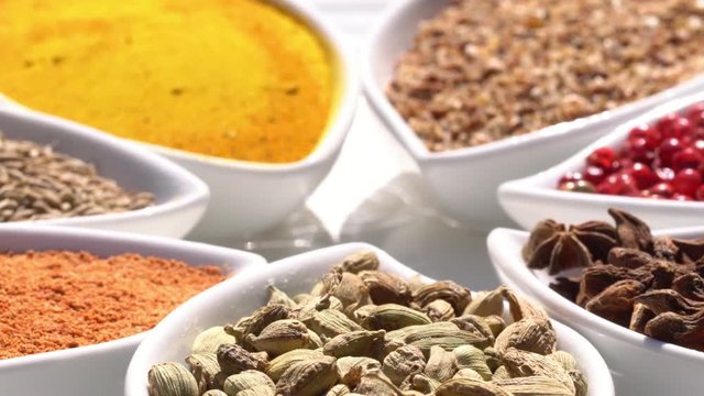 Dry spices on a rotary table. 4K. Macroshooting.