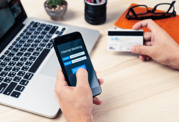 Mobile Internet Banking concept, hands holding using smart phone with personal user name and...