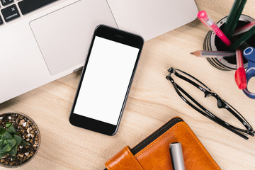 Smartphones isolated white screen for mockup design with laptop, eyeglasses and notebook on desk