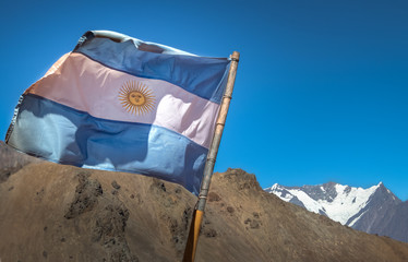 Argentina flag with Nevado Juncal Mountain on background in Cordillera de Los Andes - Mendoza Province, Argentina