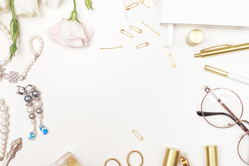 Beauty blog background. Gold style feminine accessories. Golden tinsel, scissors, pen, rings, necklace, bracelet , flowers and sweety on light background. Flat lay, top view