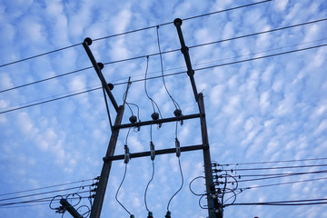 Clear blue sky with scatter clouds and electricity pole