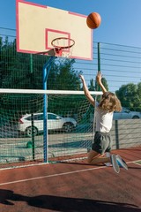 Teenager girl street basketball player on the basketball court