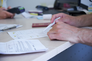 A man rents a car in the office, payment, car selection, signing the contract.