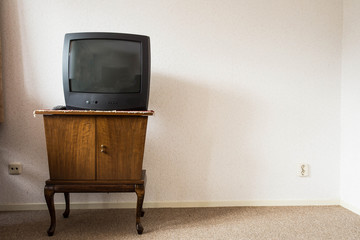 Vintage Television on wooden antique closet, old design