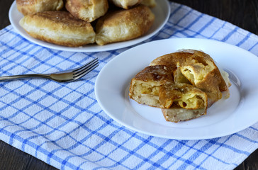 Russian kitchen. Half of the baked pies with potatoes