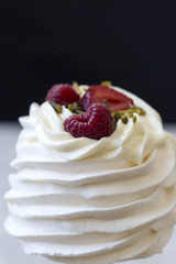 Pavlova cakes with cream and fresh summer berries