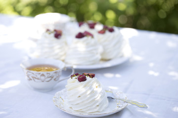 Pavlova cakes with cream and fresh summer berries