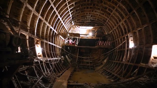 Workers are engaged in the construction of underground. Workers use tools for work.