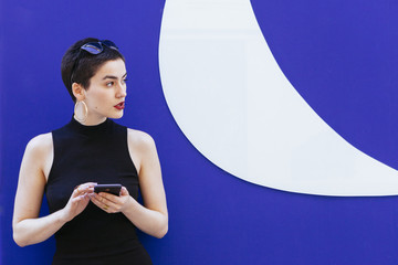 feminist woman using her telephone on the street