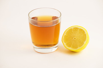 Cup of hot tea with lemon slice on a white background. Glass of ice tea with lemon. Healthy lifestyle.