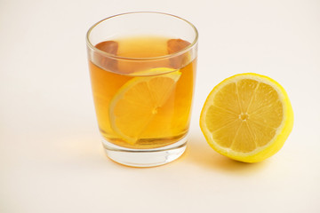 Cup of hot tea with lemon slice on a white background. Glass of ice tea with lemon. Healthy lifestyle.
