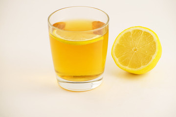 Cup of hot tea with lemon slice on a white background. Glass of ice tea with lemon. Healthy lifestyle.