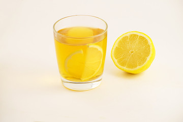 Cup of hot tea with lemon slice on a white background. Glass of ice tea with lemon. Healthy lifestyle.