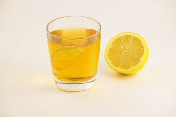 Cup of hot tea with lemon slice on a white background. Glass of ice tea with lemon. Healthy lifestyle.