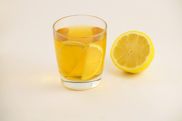 Cup of hot tea with lemon slice on a white background. Glass of ice tea with lemon. Healthy lifestyle.