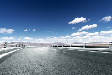 highway through mountain with blue sky