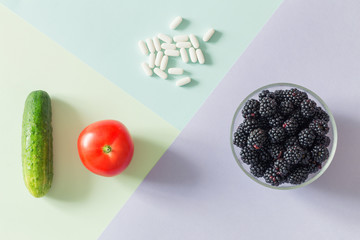 Medical pills and fresh, healthy fruit a source of natural vitamins