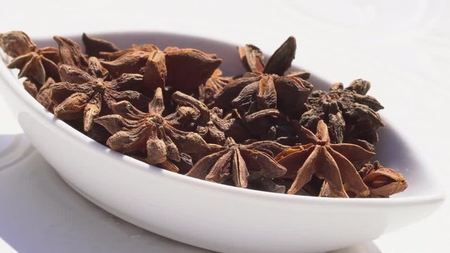 Dry spices anisetree on a rotary table. 4K. Macroshooting.