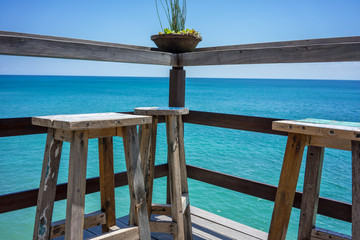 wood chair on beach bar with blue sky ocean view