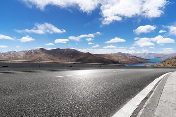 highway through mountain with blue sky