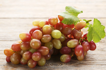 Red grape on grey wooden table