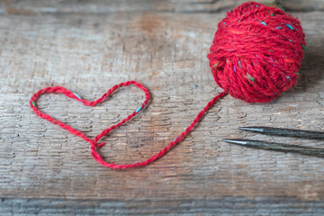 Bright red tweed wool yarn with heart shaped thread, knitting postcard