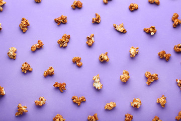 Caramel popcorn on purple background