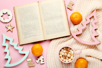 Fototapeta na wymiar Cup of coffee with mandarins, book and gingerbread cookies
