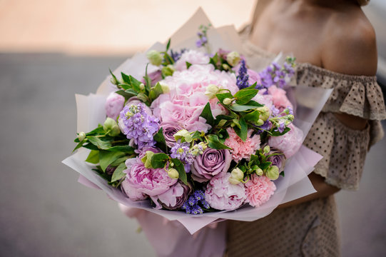 Young girl holding a bouquet of tender violet flowers