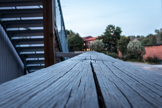 Macro perspective view of wood railing  on building outdoors.
