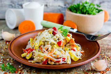 Chicken pad thai rice noodles with fried egg, onion, carrot, pepper