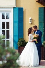 Beautiful Bride and Groom enjoy each other. happy romantic young couple celebrating their marriage. Sexy kissing stylish couple of lovers close up portrait. wedding concept.