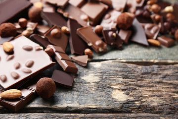 Chocolate pieces with nuts on wooden table