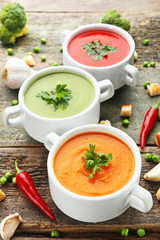 Vegetable cream soup with parsley on grey wooden table