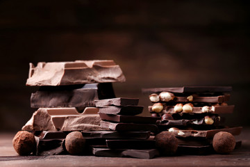 Chocolate pieces with candy balls on wooden table