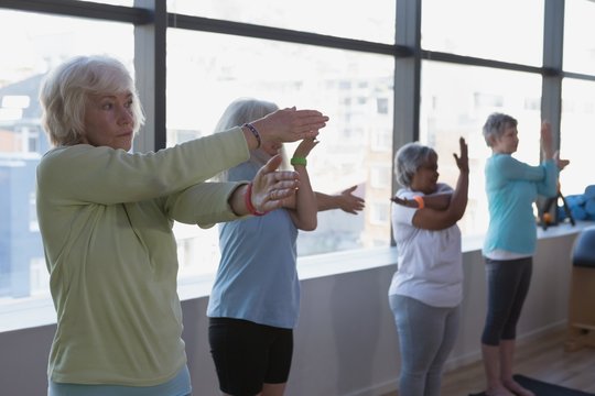 Group of senior women performing yoga