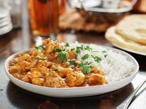 plate of indian curry with basmati rice and chicken