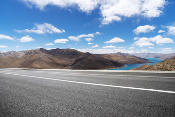 highway through mountain with blue sky