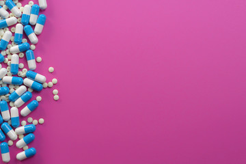 Pills in corner on pink background textspace