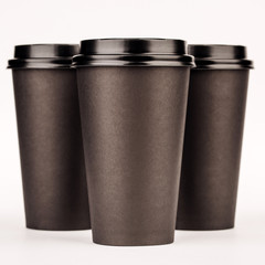 black paper cups on white background.