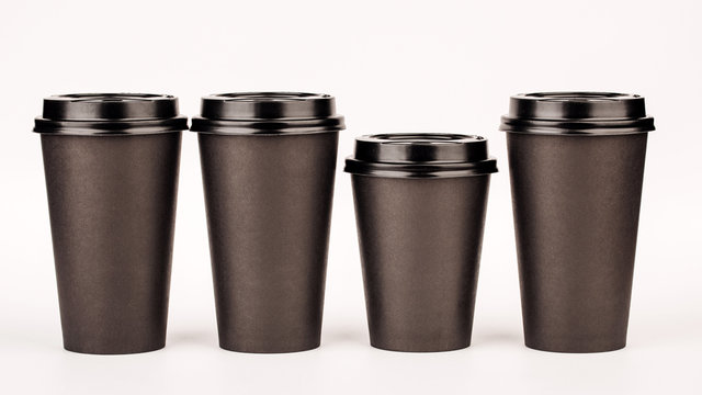 black paper cups on white background.