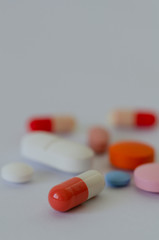 Many different colors pills and tablets isolated on white background
