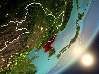 Sun rising above North Korea from space