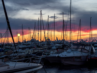 boats in seaport with sunset