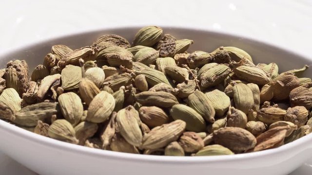 Dry spices cardamom on a rotary table. 4K. Macroshooting.