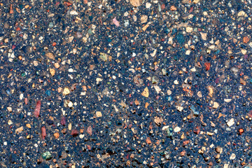Wet colored asphalt texture. Macro