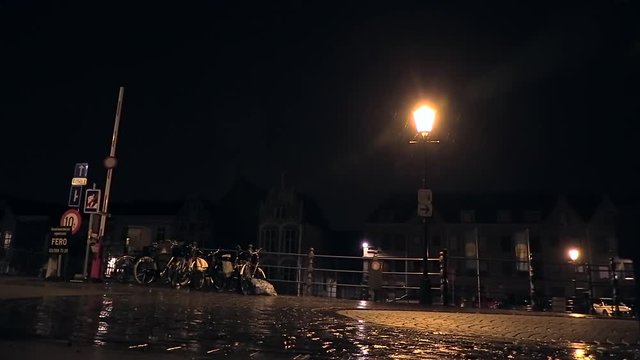 lightning strike and pouring rain at night in the city of Mechelen, Belgium LOW ANGLE SHOT